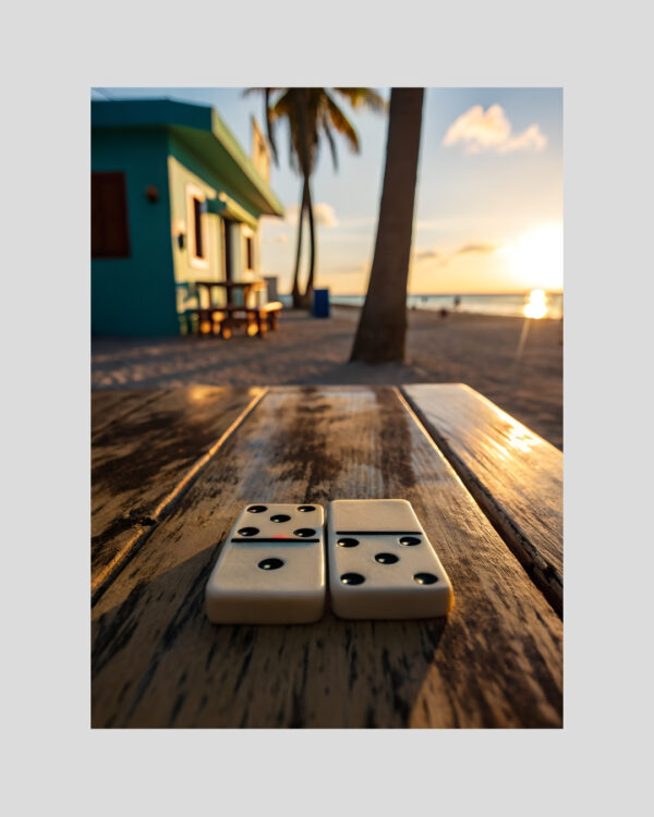 Affiche artistique de deux dominos sur une table en bois avec vue sur la plage antillaise au coucher du soleil
